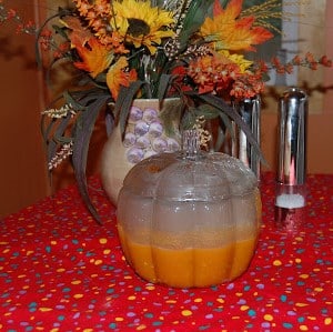 Hot pumpkin Soup in a Pumpkin Bowl in fall setting